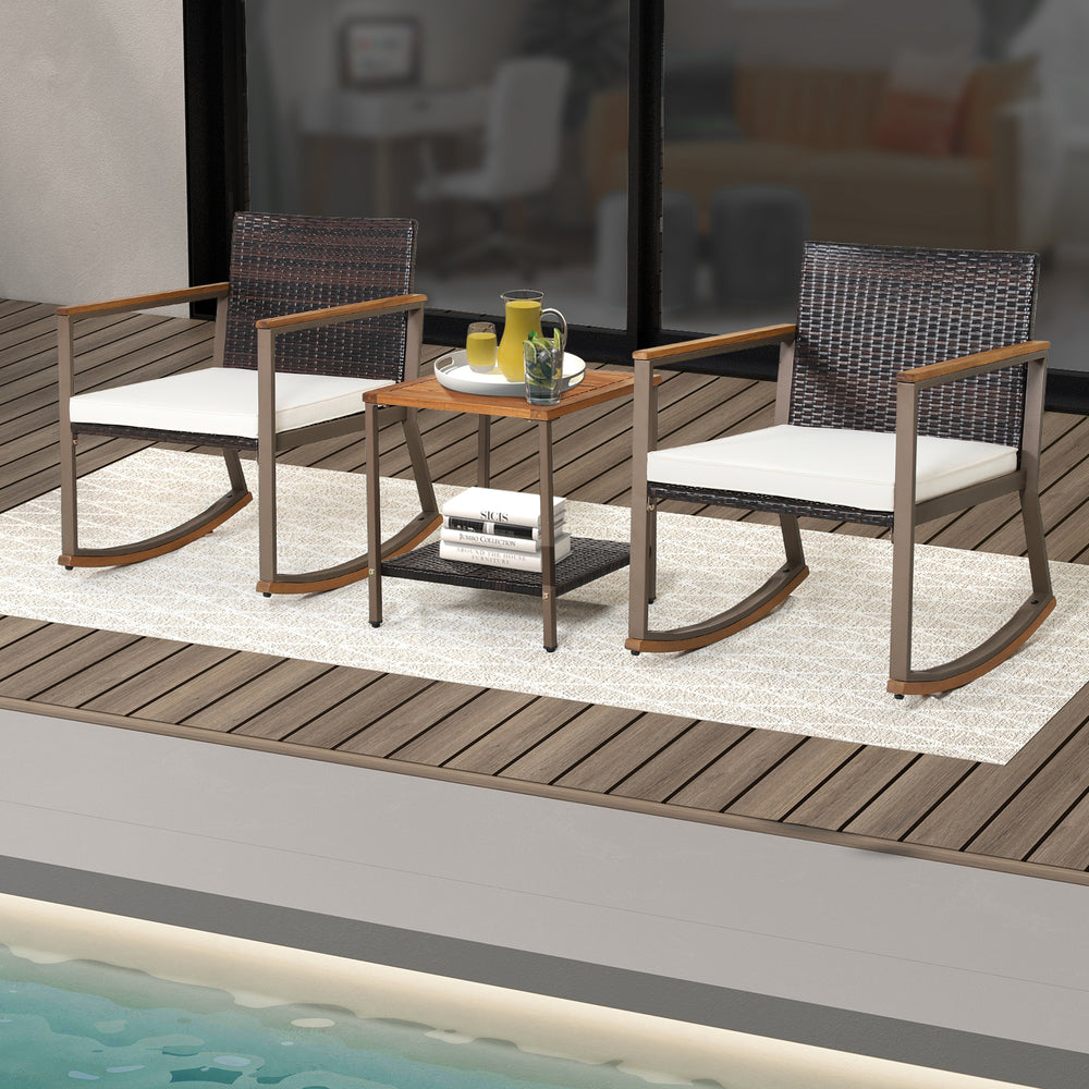 3-piece rattan rocking bistro set with off-white cushions and a double-tier coffee table, perfect for outdoor.