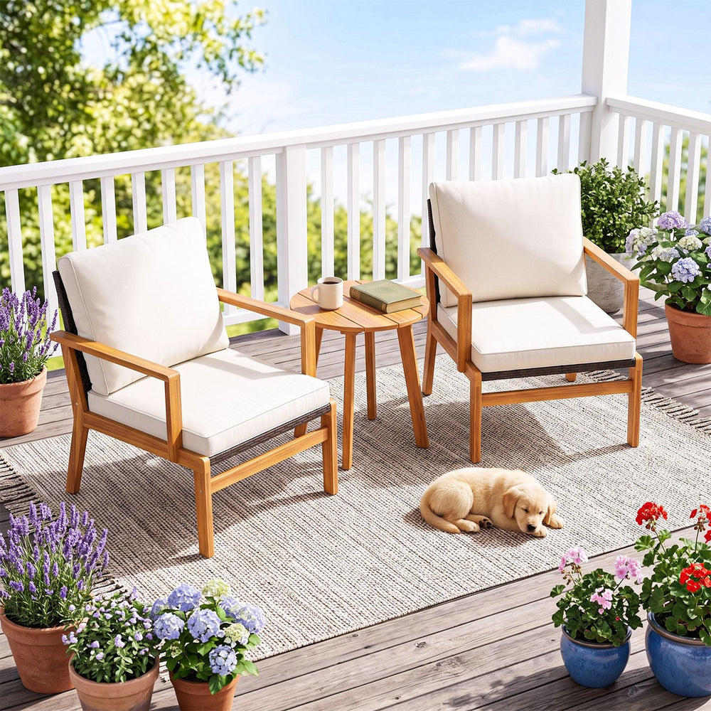 Two acacia wood chairs with off-white cushions and a side table, perfect for patio or balcony relaxation.