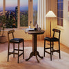 Round wood bar table set for 2 with pedestal base and armless stools, perfect for intimate meals in a cozy setting.