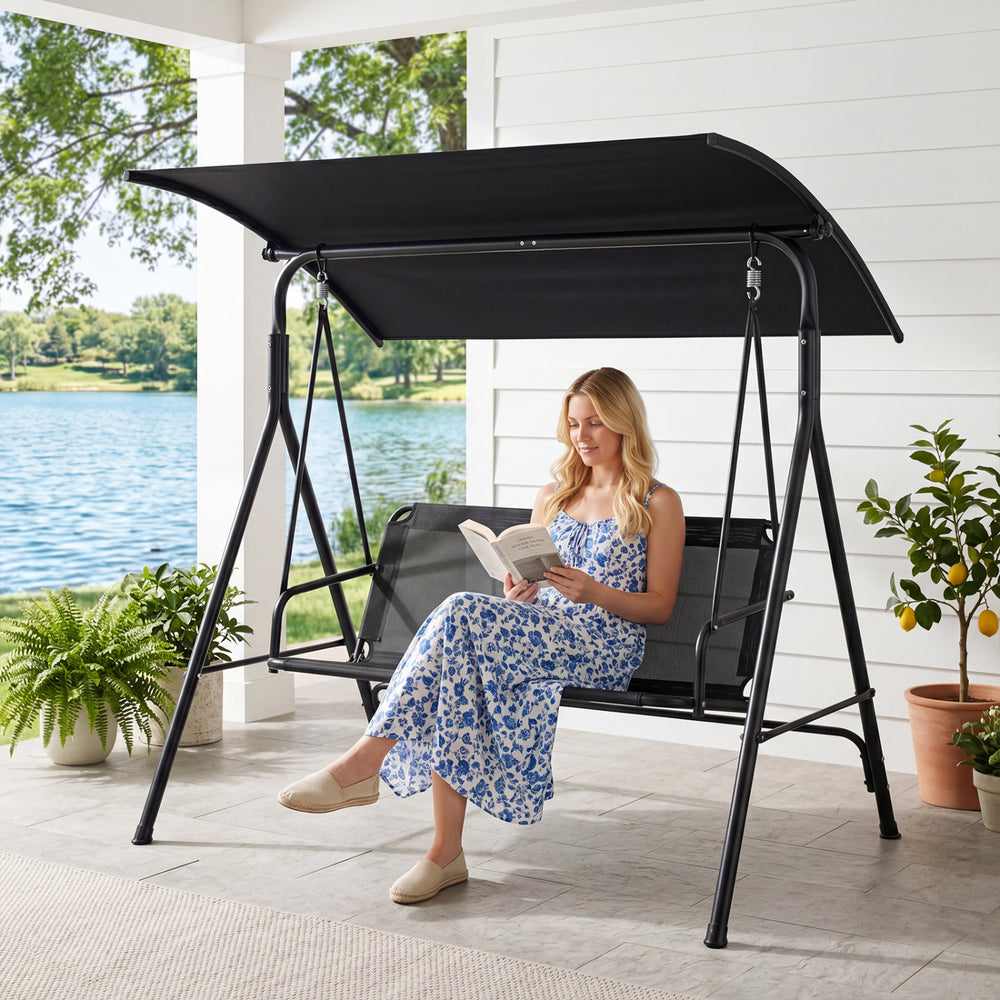 Three-seat patio swing chair with adjustable canopy, heavy-duty metal frame, and breathable mesh fabric for outdoor.