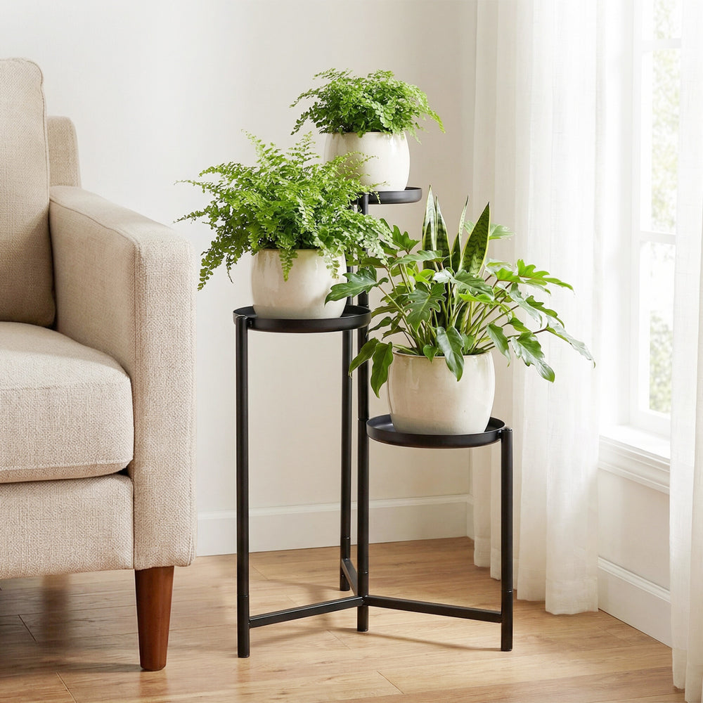3-tier metal plant stand with a triangular frame, perfect for corner display of pots and decorations in indoor spaces.