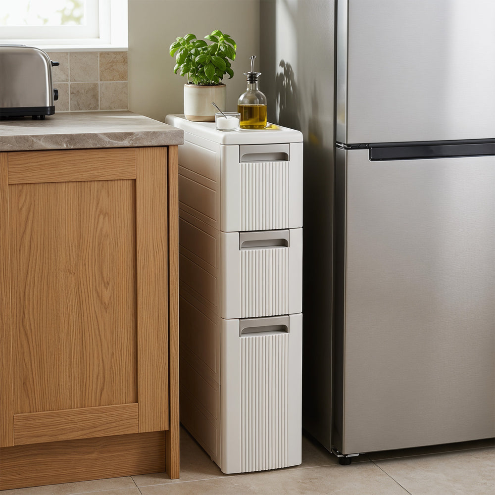 Narrow 3-tier beige storage cabinet with three drawers, removable dividers, and smooth rolling wheels for versatile organization.