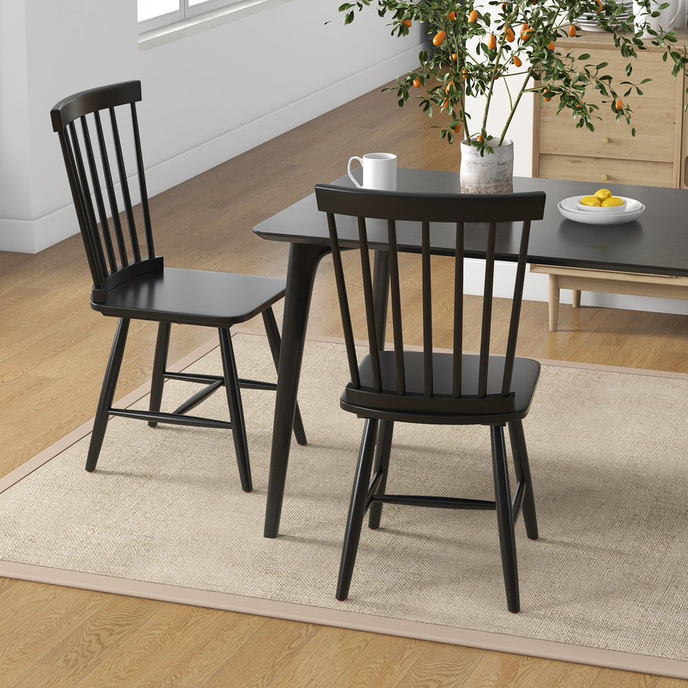 Windsor chairs from the 3-in-1 dining set with a black finish, paired with an industrial sideboard for stylish dining.