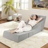 Gray 3-in-1 folding sofa bed with a relaxed user reclining, showcasing the cozy inclined backrest and corduroy cover.