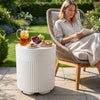 The white 3-in-1 outdoor cooler side table features a fluted design and insulated interior for keeping drinks cold.
