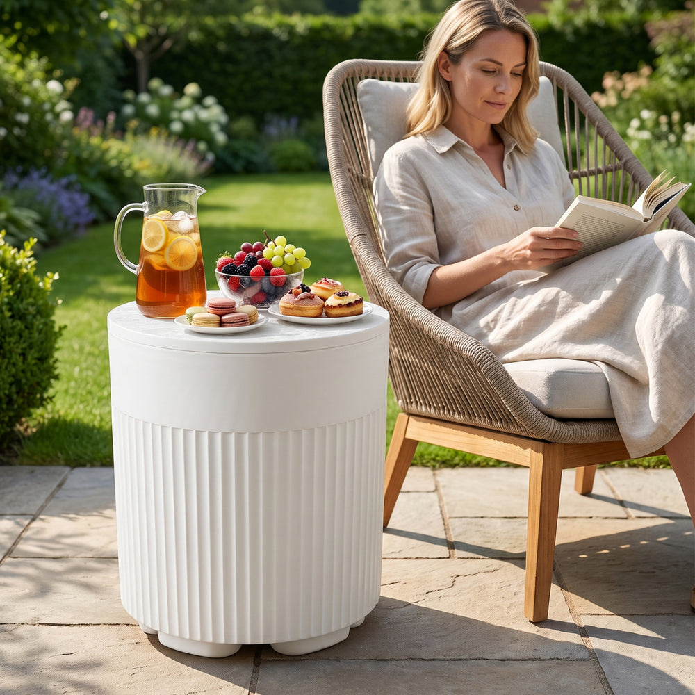 The white 3-in-1 outdoor cooler side table features a fluted design and insulated interior for keeping drinks cold.