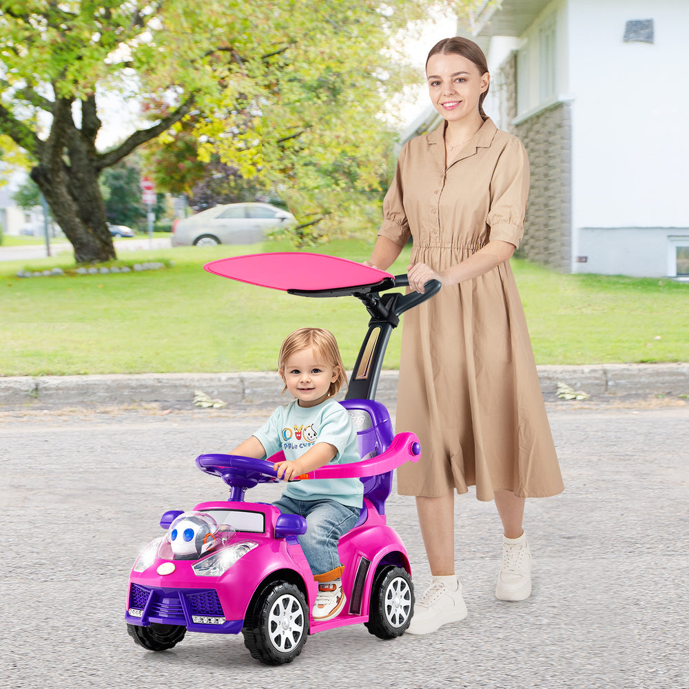 Toddler riding in a pink 3-in-1 push car stroller with adjustable canopy, designed for boys and girls aged 1+.