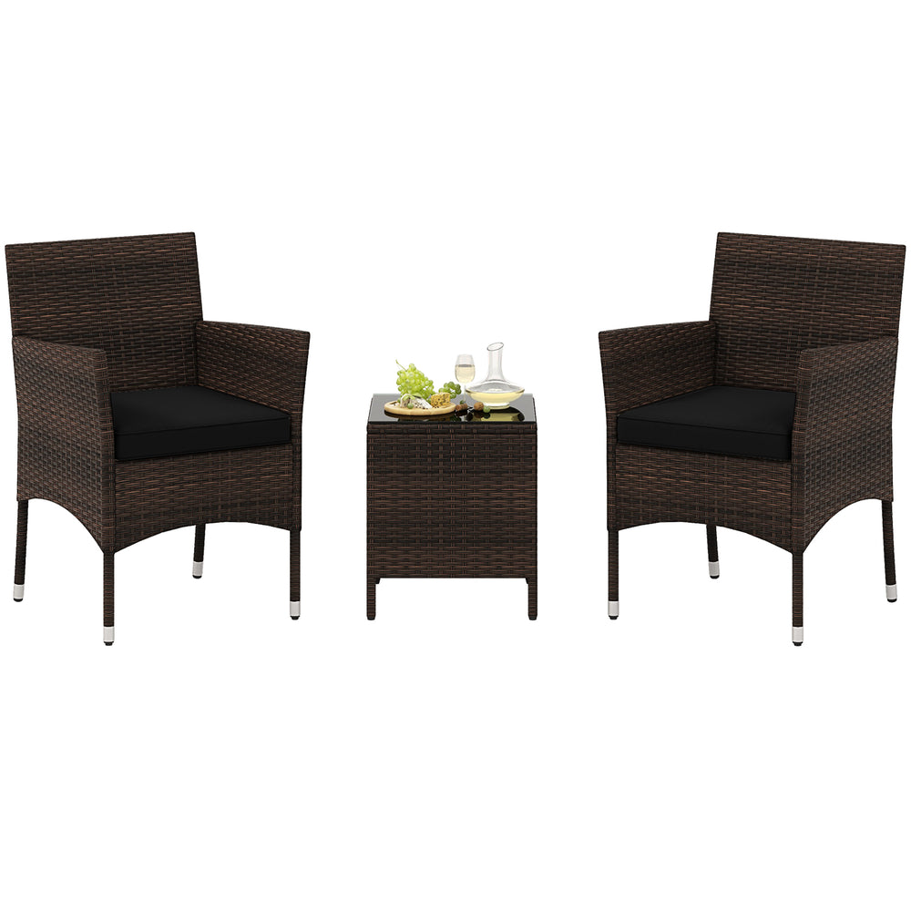 Two cushioned outdoor chairs with a square glass tabletop, made of durable rattan, perfect for poolside relaxation.