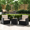 Two off-white cushioned chairs with a glass-top table in a patio setting, ideal for outdoor relaxation.