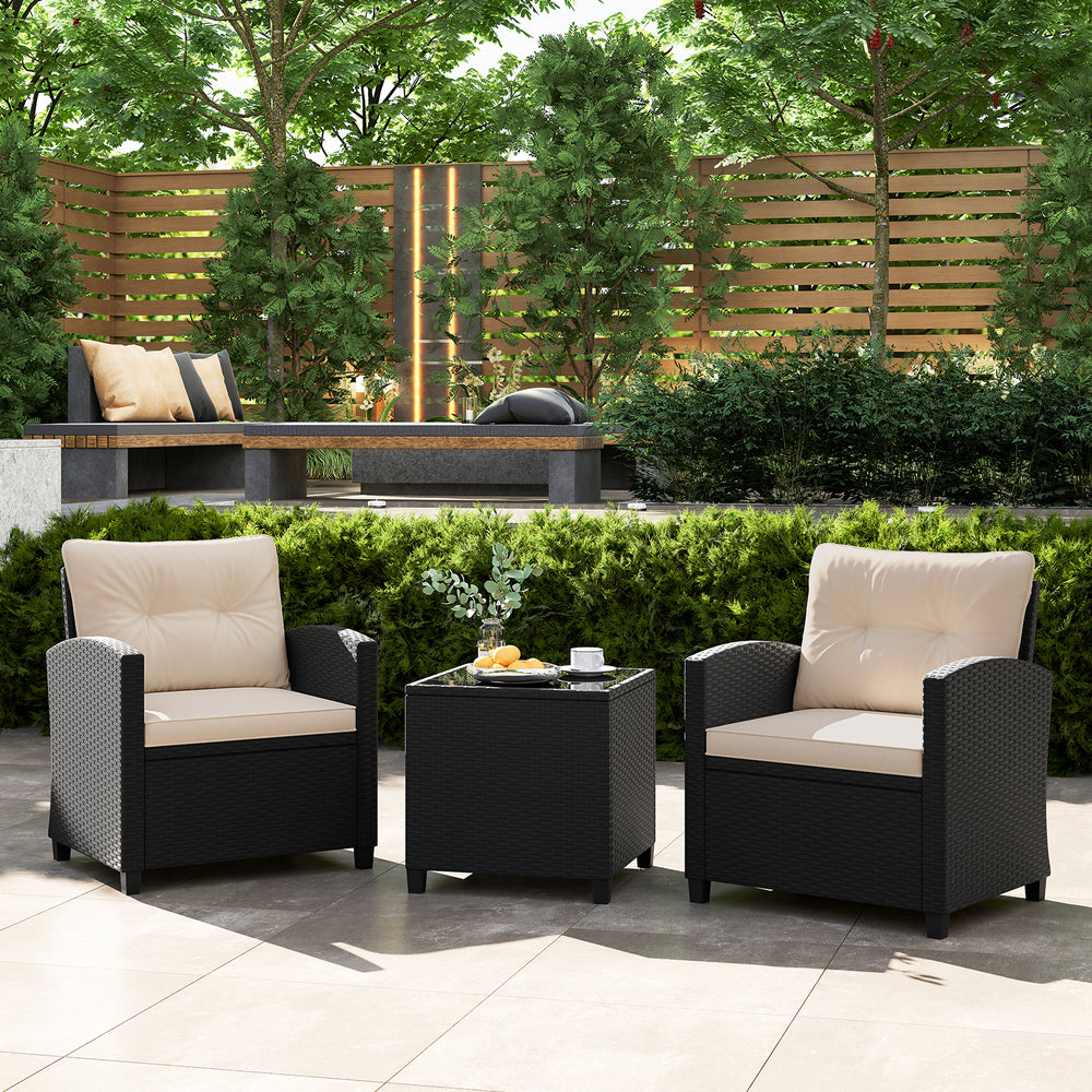 Two off-white cushioned chairs with a glass-top table in a patio setting, ideal for outdoor relaxation.