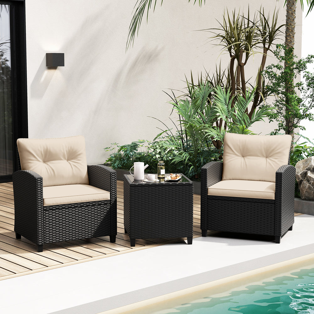 Two off-white cushioned patio chairs with a tempered glass coffee table, ideal for outdoor relaxation by the poolside.