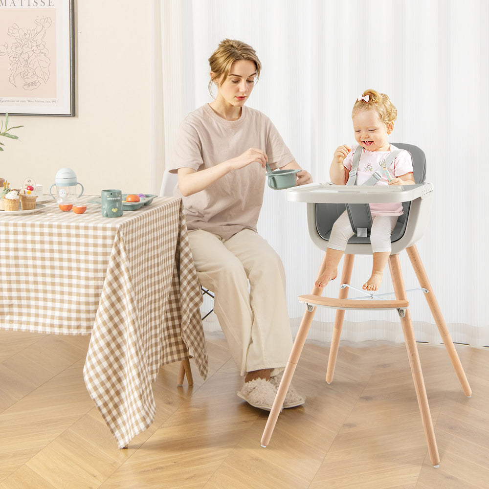 3-in-1 convertible wooden high chair in gray with adjustable tray, cushion, and five-point harness for baby safety.