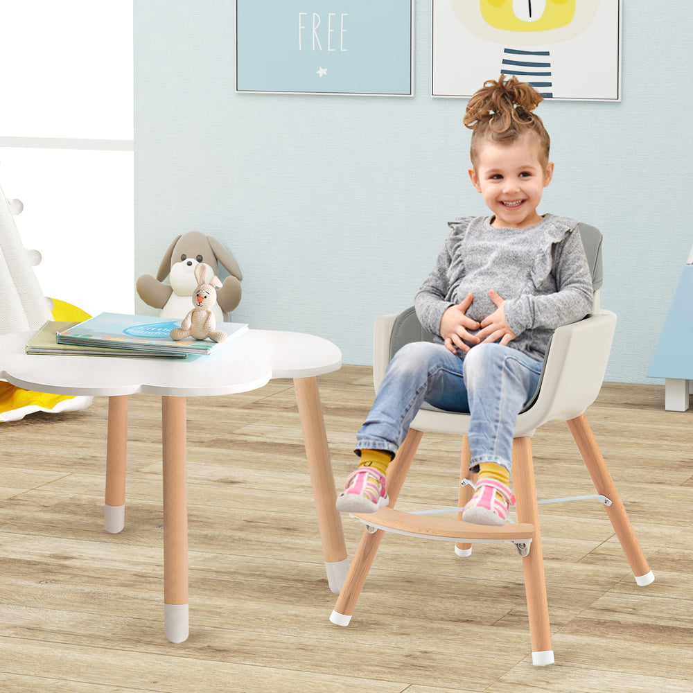 Convertible wooden high chair in gray with detachable tray, designed for safety and comfort for growing babies.