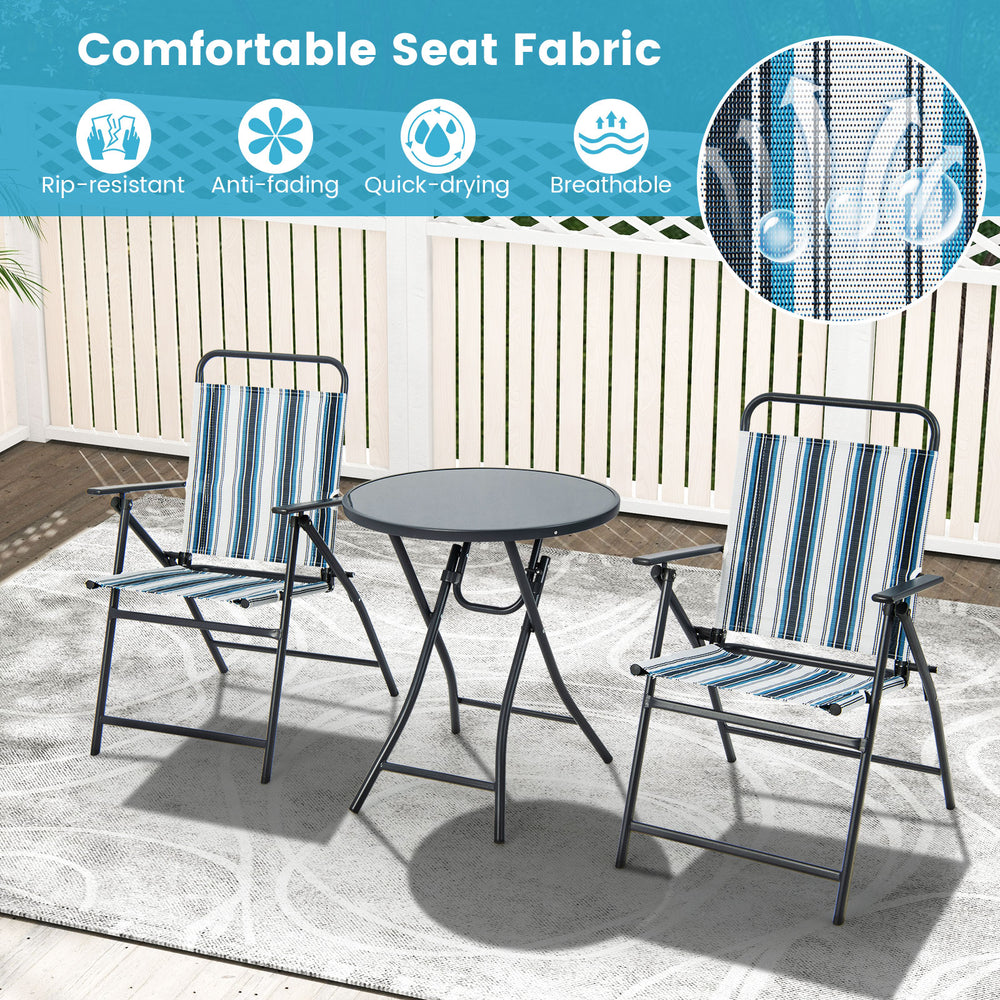 Two striped folding chairs and a round table in a patio setting, featuring breathable fabric and a heavy-duty metal.
