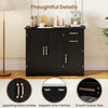Close-up of the elegant gold-tone metal handles on the black modern kitchen sideboard buffet cabinet for a stylish.