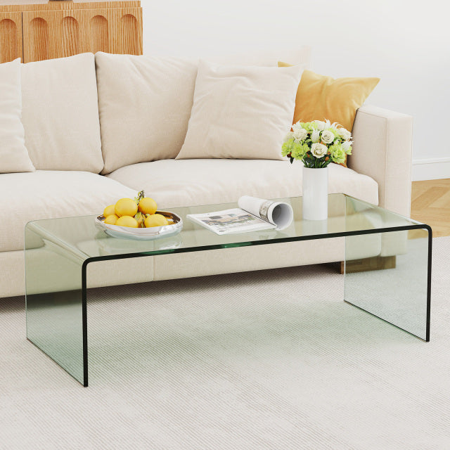 Clear tempered glass coffee table with rounded edges, 42 x 19.7 inches, ideal for a bright and elegant living room.