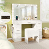 Compact white vanity desk with a charging station and stool, featuring an LED mirror for stylish bedroom convenience.