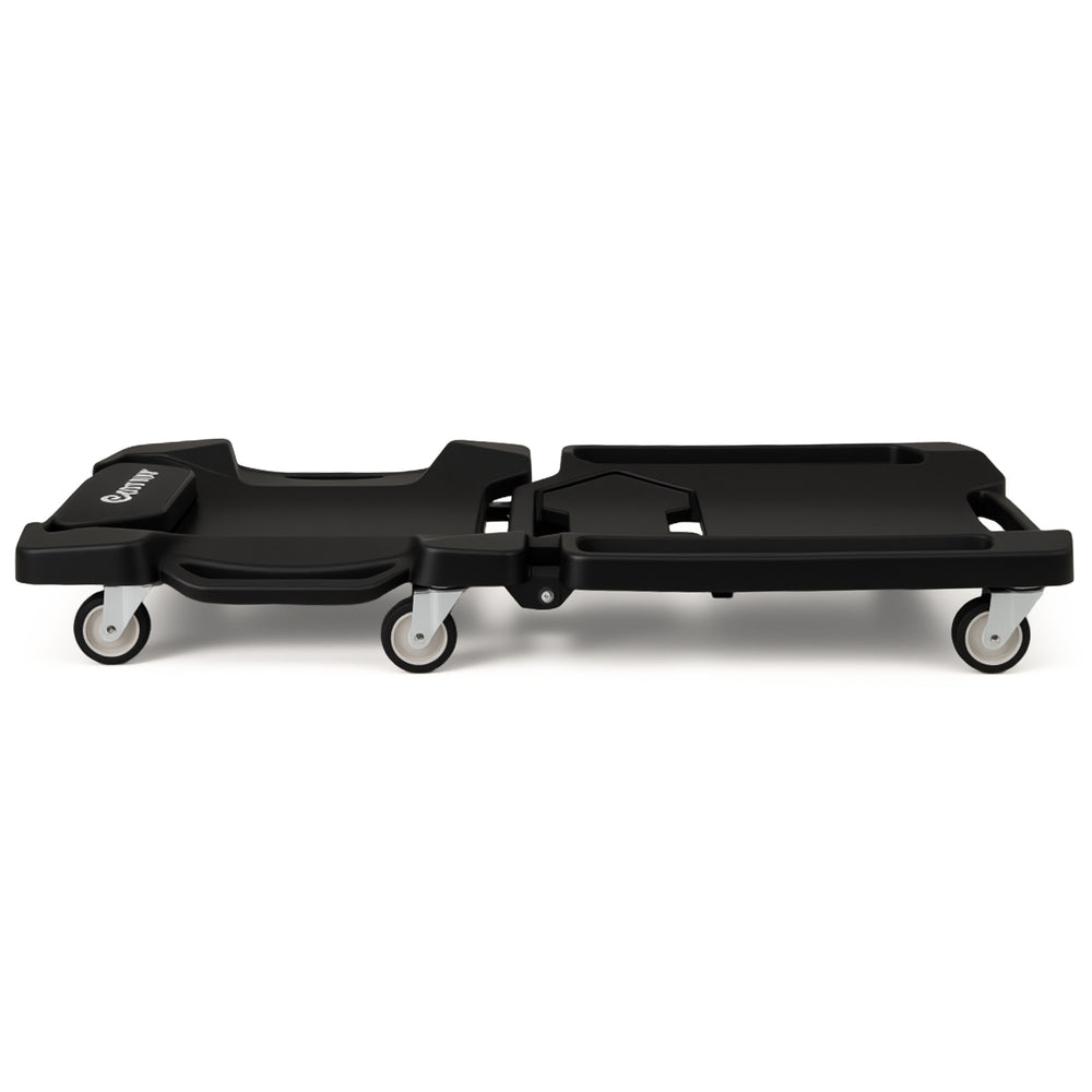 Foldable mechanic creeper with padded headrest, tool trays, and 350 lbs capacity, ideal for tight car spaces.