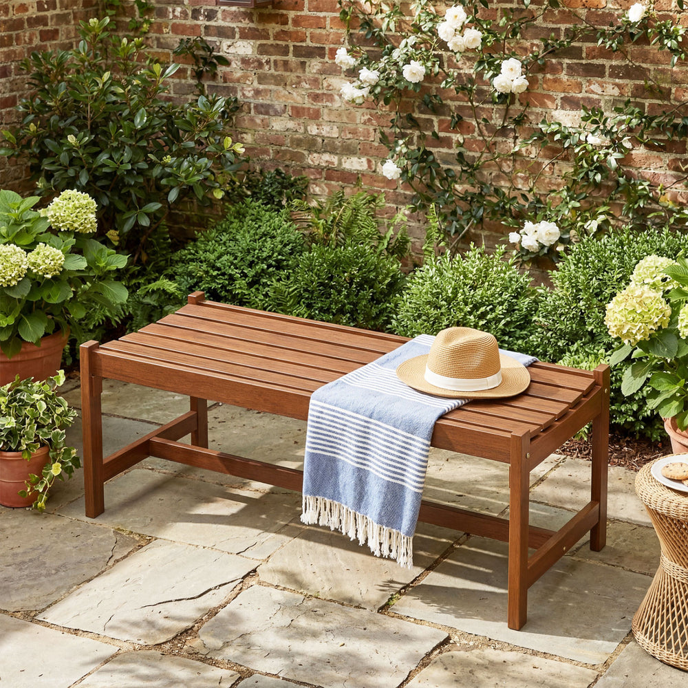 44-inch outdoor solid hardwood bench with teak oil finish, perfect for patios and gardens, featuring a slatted design.