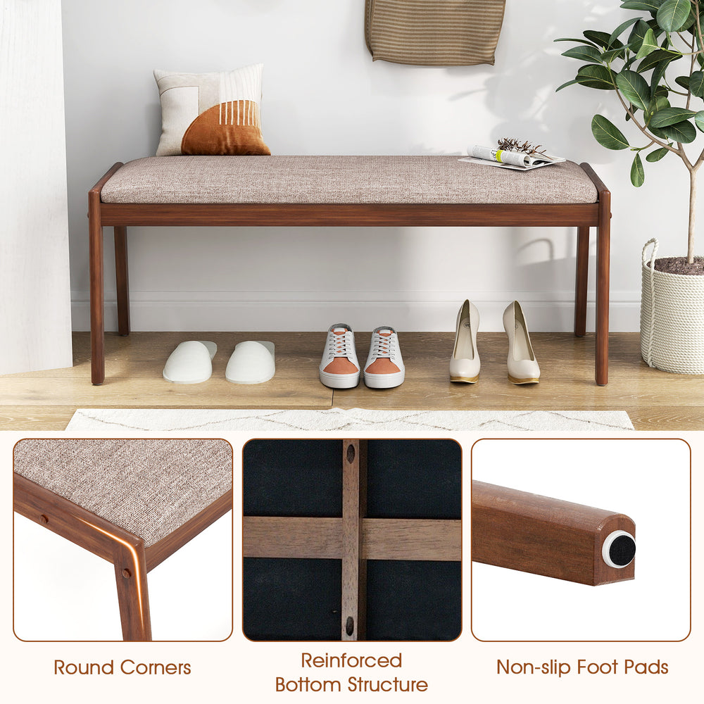 Farmhouse backless bench with rubber wood legs and beige fabric padded seat, ideal for entryway or dining room use.