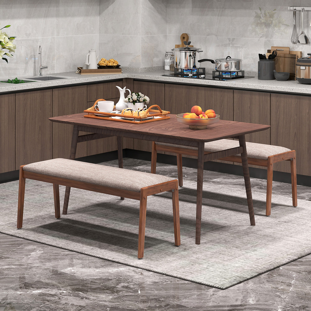 Backless bench with rubber wood legs and beige fabric padded seat, ideal for farmhouse-style dining rooms.