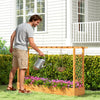 Gardener watering flowers in a 45-inch wooden raised garden bed with lattice trellis, made of durable natural pine.