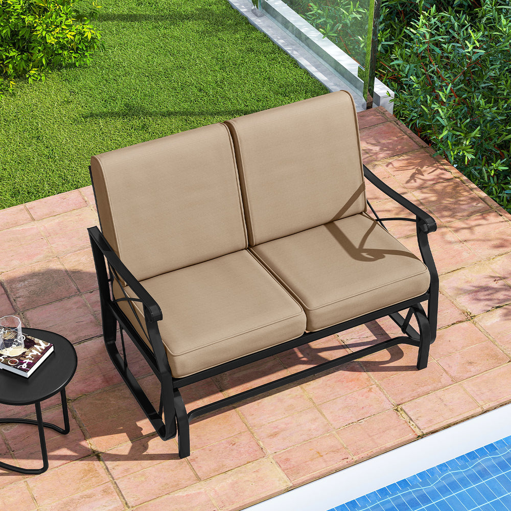 Outdoor 2-person glider rocking loveseat with thick brown cushions and metal frame, perfect for patio relaxation.