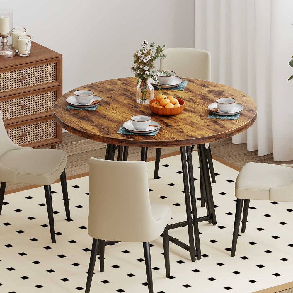 Rustic brown round dining table with smooth edges and metal legs, comfortably seating 4-6 people for stylish meals.