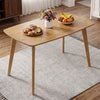 Solid wood dining table for 4 with rounded edges, made from rubber wood, perfect for family meals in any setting.