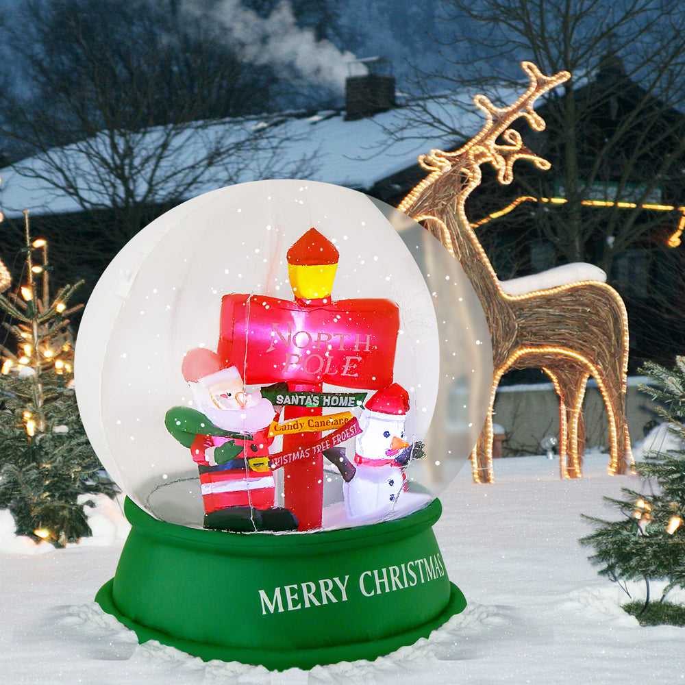 4 feet Christmas inflatable snow globe showcasing a Santa and snowman with a decorative road sign, perfect for holiday.