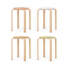 Set of 4 multicolor bentwood stackable stools with round tops, featuring sturdy wooden legs and non-slip foot pads.