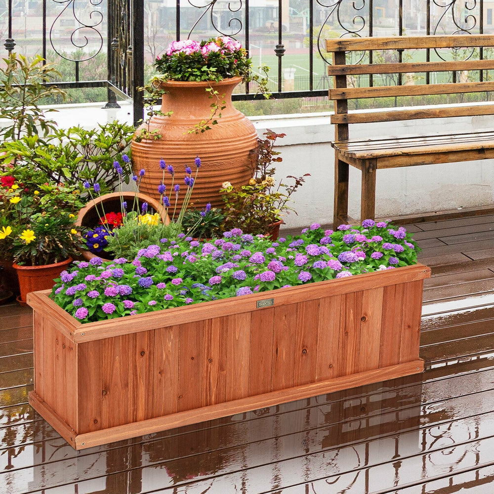Wooden decorative planter box made of natural fir, featuring vibrant flowers, ideal for garden or patio use.