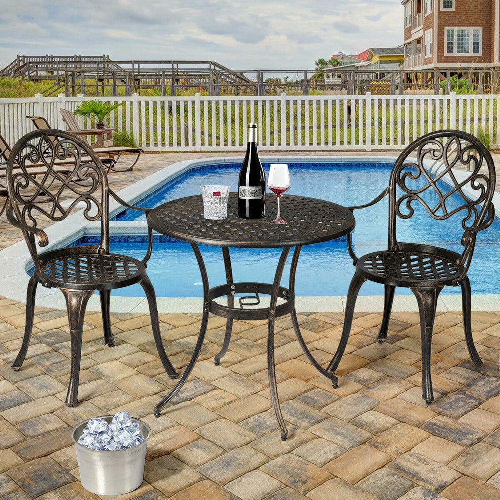 Bistro table set with two chairs in antique bronze finish, featuring a removable ice bucket, ideal for poolside.