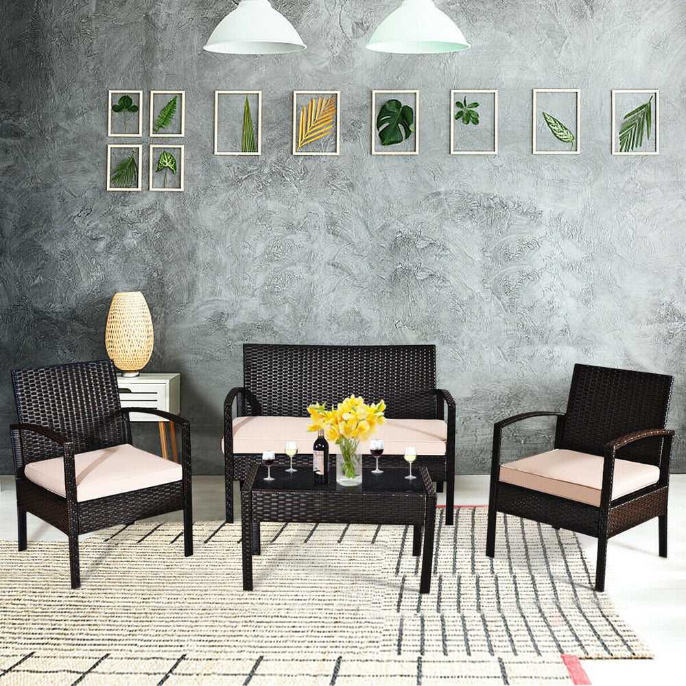 4-piece patio rattan conversation set featuring a loveseat, two chairs, and a coffee table with beige cushions for.