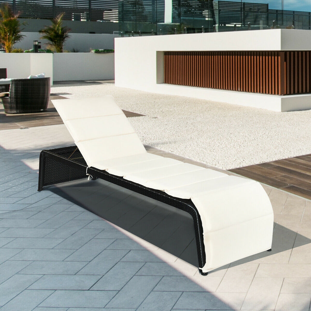 Adjustable patio rattan lounge chair with white cushioned seat, perfect for poolside relaxation and outdoor comfort.