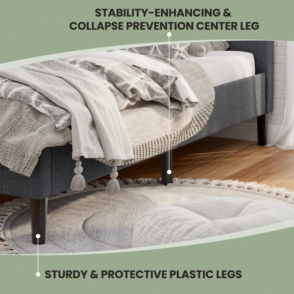 Close-up of the gray platform bed's tufted headboard and sturdy plastic legs, designed for stability and style.