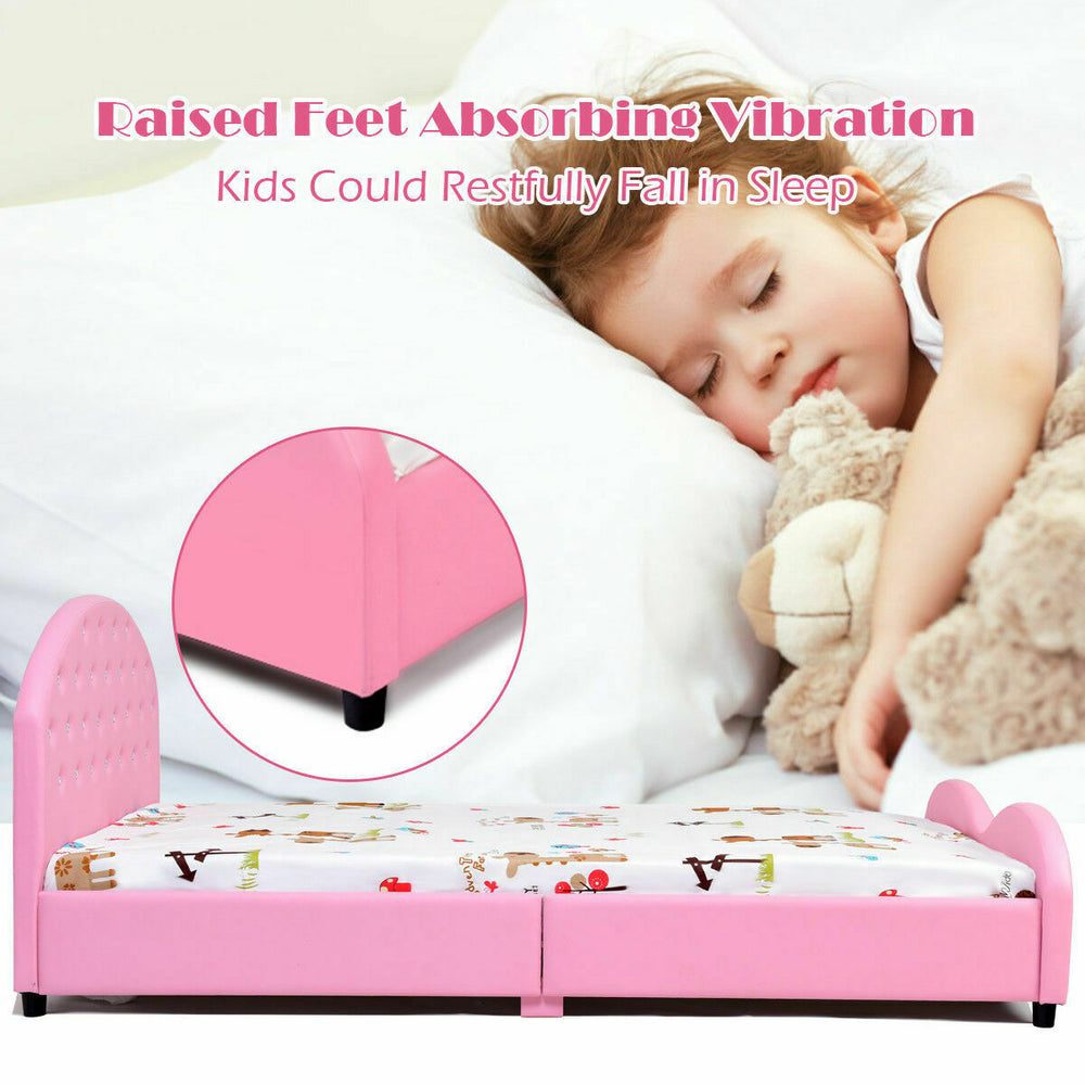 Twin size upholstered toddler bed in pink with raised feet, designed for safety and comfort for kids' restful sleep.
