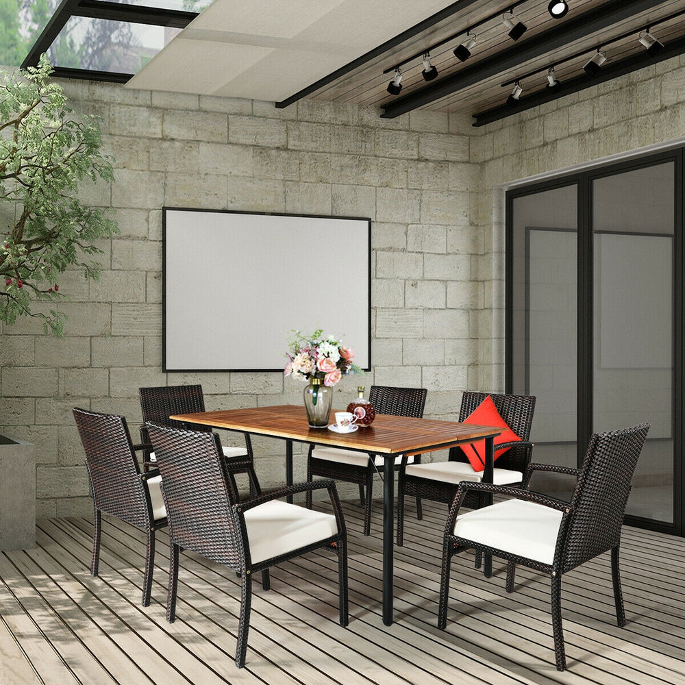 7-piece patio rattan dining set featuring a spacious acacia wood table and 6 cushioned armchairs, perfect for outdoor.
