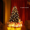 6 feet hinged black artificial Christmas tree with 1036 branch tips, perfect for indoor and outdoor holiday decoration.