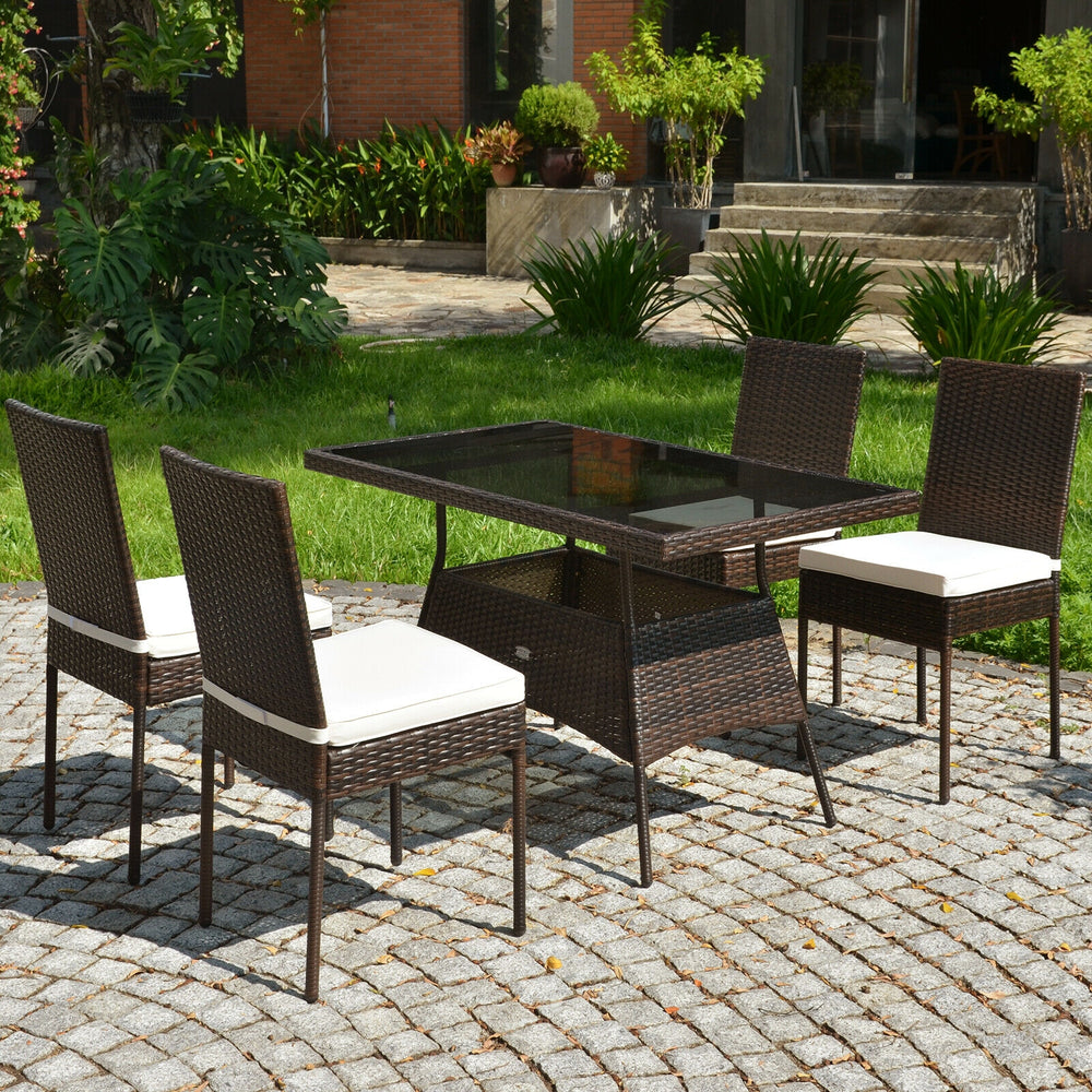 5-piece rattan dining set featuring a glass table and high back chairs with removable cushions, perfect for outdoor.