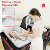Diaper changing table with safety belt on a 4-in-1 portable baby play yard, featuring a soft mattress and hanging toys.