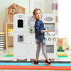 Kids playing with a white kitchen pretend play cookware set, featuring a water dispenser and realistic design for.