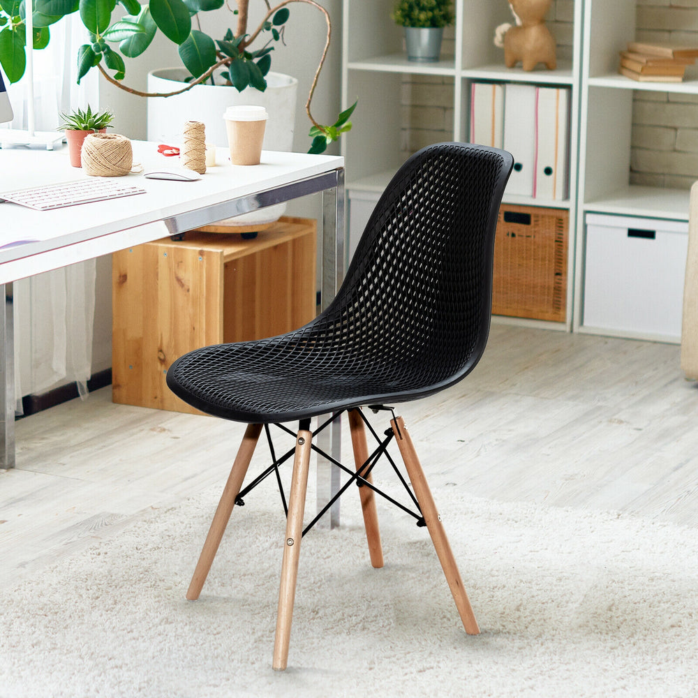 Black plastic hollow chair with wood legs, featuring a curved mesh seat for breathability, ideal for dining or office.