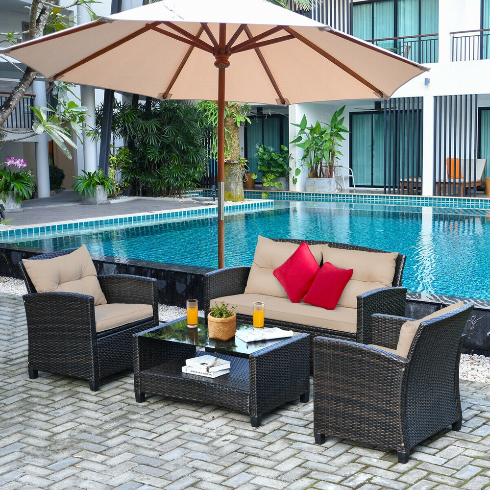 4-piece outdoor rattan furniture set featuring a loveseat, two single sofas, and a glass table, perfect for backyard.