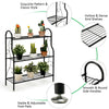 3-tier black metal plant stand with scrollwork design, featuring sturdy shelves for plants and adjustable foot pads for.