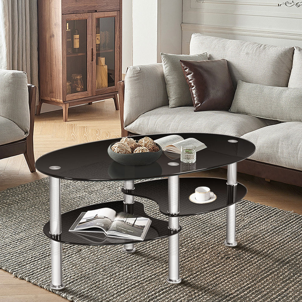 Oval black tempered glass coffee table with two bottom shelves, ideal for living room storage and elegant decor.