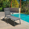 Gray patio reclining chaise lounge with adjustable neck pillow, perfect for sunbathing and outdoor relaxation by the.