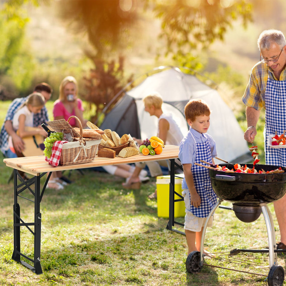 Outdoor wood folding picnic table with adjustable heights, perfect for barbecues and gatherings in natural settings.