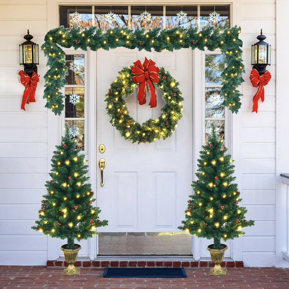 Christmas decoration set featuring a pre-lit wreath, garland, and two entrance trees with red berries for festive charm.