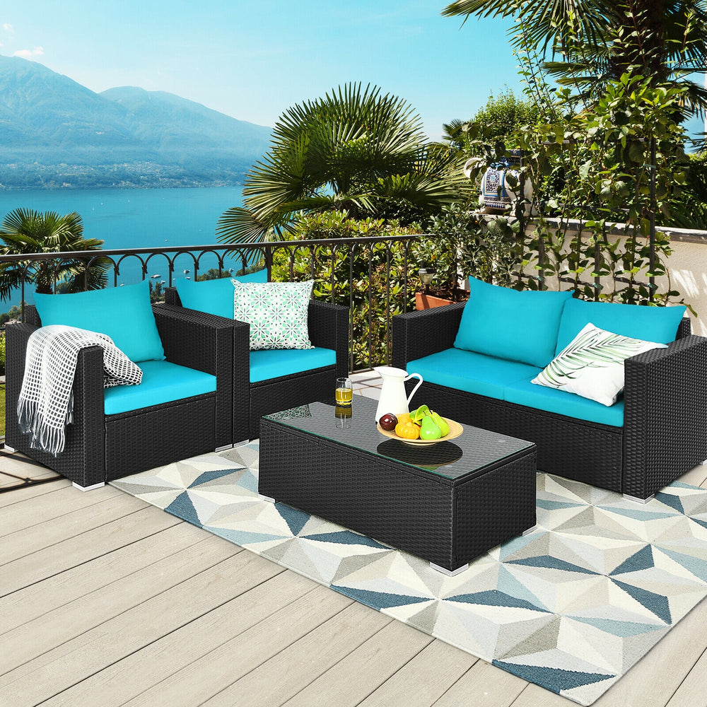 Patio rattan furniture set with turquoise cushions, featuring a coffee table and comfortable seating for outdoor.